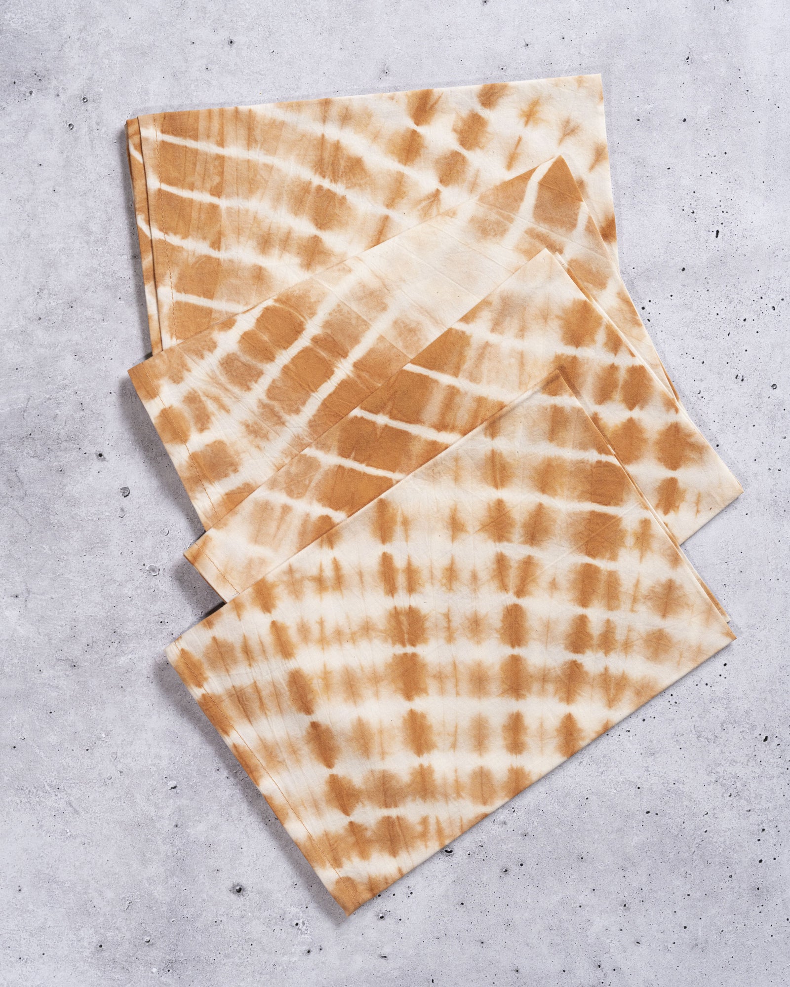 Hand-dyed amber Shibori cotton napkin, eco-friendly tie-dye dinner tableware