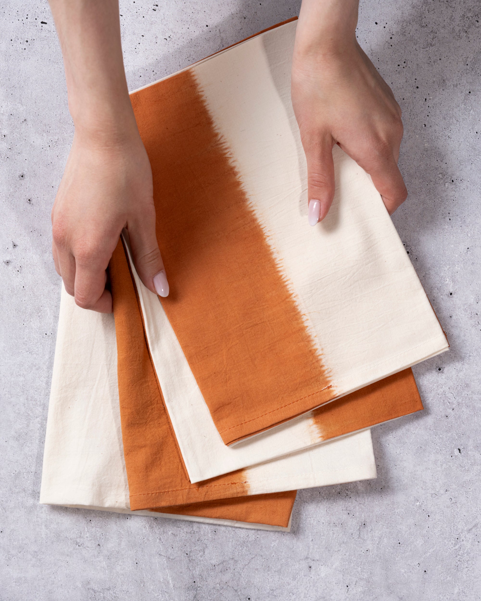 Amber ombré cotton napkin with Shibori tie-dye design, reusable and washable